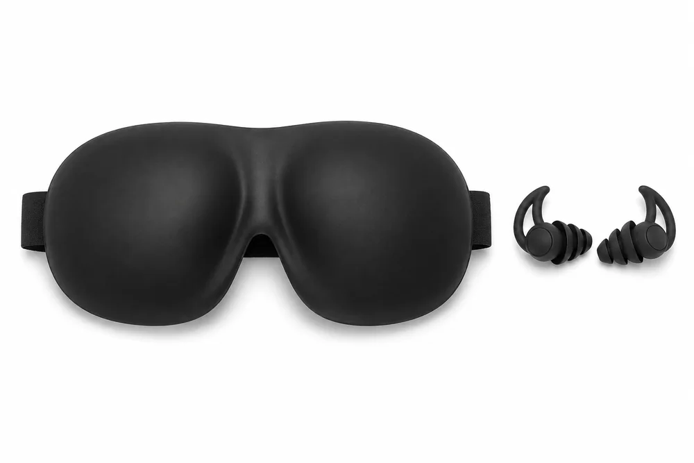 A sleep mask and a pair of earplugs on a white surface