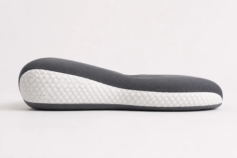 The pillow in profile: the raised roll along the front edge, with the lower hollow behind it